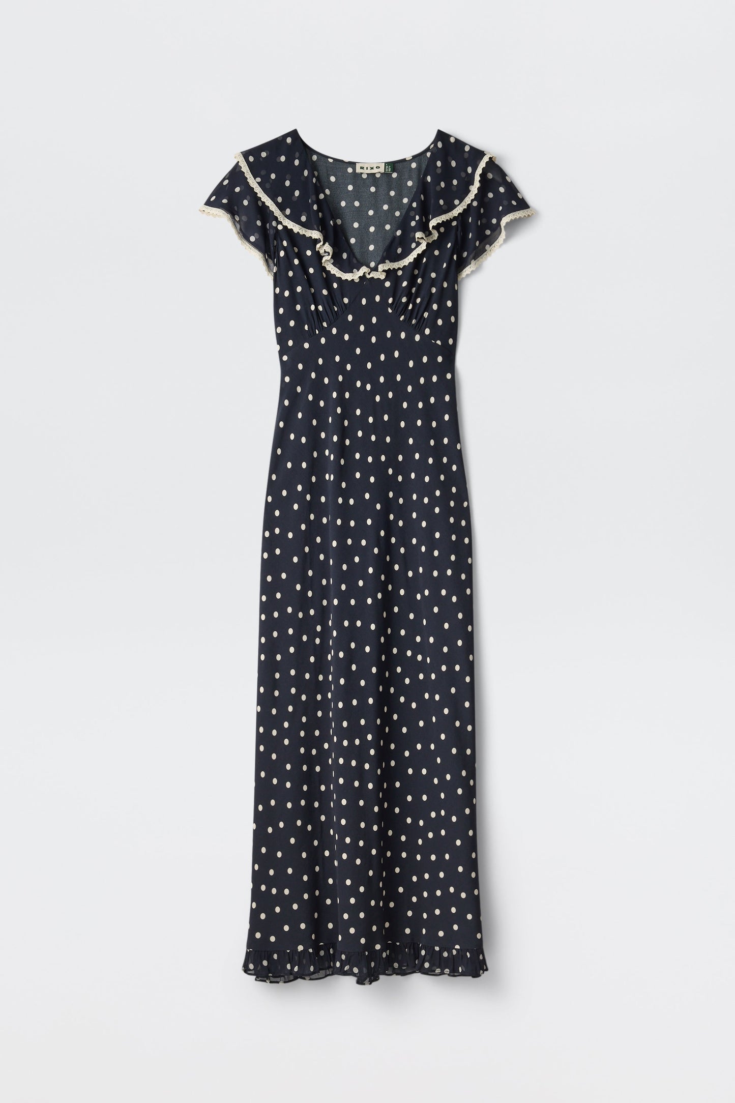 Bethea - Layla Dot Navy: Navy blue short-sleeve maxi dress with white polka dots, ruffled neckline, and hem, shown on a plain white background.